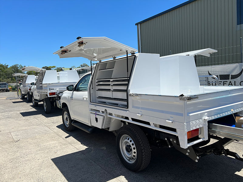 Three white utes, with their lock box opened on display