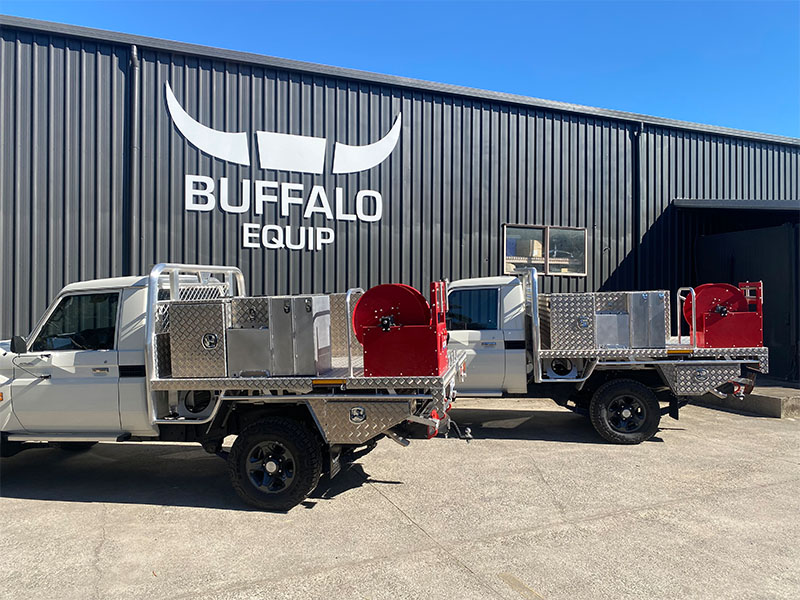 Two mining utes with tray accessories on them